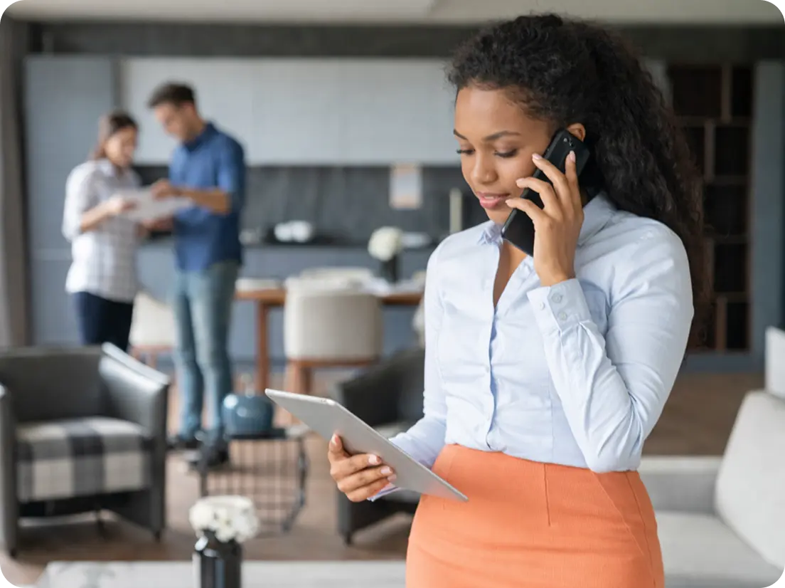 Modern real estate office with agent using OctoVoIP cloud phone system and property dashboard